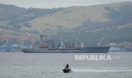 Seorang pria dengan jetski melewati kapal pemasok USNS Big Horn Amerika yang berlabuh di dekat galangan kapal di tempat yang dulunya merupakan pangkalan angkatan laut luar negeri terbesar Amerika di Subic Bay Freeport Zone, provinsi Zambales, barat laut Manila, Filipina pada Senin 6 Februari 2023 AS telah membangun kembali kekuatan militernya di Filipina.