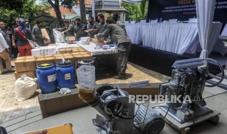 Petugas BNN mengemas barang bukti narkoba saat konferensi pers pengungkapan kasus laboratorium rahasia (clandestine lab) narkotika di Taktakan, Kota Serang, Banten, Rabu (2/10/2024). Petugas BNN menangkap 10 orang tersangka beserta barang bukti narkotika golongan 1 jenis PCC sebanyak 971.000 butir senilai Rp145 miliar, enam unit mesin produksi narkotika, dan bahan baku pembuatan narkotika. 