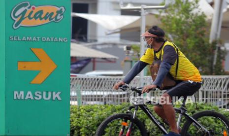 Warga bersepeda melintasi Gerai Giant Ekspres di Lebak Bulus, Jakarta, Kamis (27/5/2021). PT Hero Supermarket Tbk atau HERO Group memutuskan untuk menutup seluruh gerai supermarket Giant di Indonesia mulai akhir Juli 2021 dan fokus mengembangkan IKEA, Guardian, serta Hero Supermarket. 