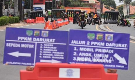 Warga mengendarai motor melintasi di Pos Penyekatan Mobilitas Masyarakat pada PPKM Darurat di Jalan Raya Bogor, Jakarta, Selasa (20/7/2021). Mobilitas warga di kawasan aglomerasi terpantau lebih rendah dibandingkan di hari biasa masa PPKM Darurat menyusul himbauan Menteri Agama untuk membatasi aktivitas warga untuk bepergian atau mudik pada Hari Raya Idul Adha. 