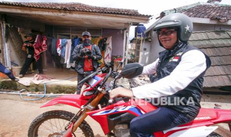 Gubernur Jawa Barat Ridwan Kamil menggunakan sepeda motor saat meninjau lokasi bencana gempa bumi di Desa Gasol, Kabupaten Cianjur, Jawa Barat, Jumat (25/11/2022).