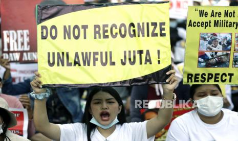  Para pengunjuk rasa memegang spanduk selama protes menentang kudeta militer, dekat Kedutaan Besar Indonesia di Yangon, Myanmar, 26 Februari 2021. Protes anti-kudeta terus berlanjut di Myanmar di tengah upaya diplomatik regional untuk mencapai resolusi terhadap kerusuhan berminggu-minggu yang disebabkan oleh kudeta militer.