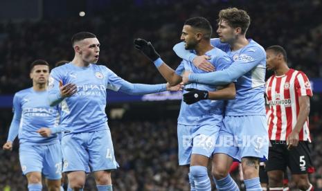 Pemain Manchester City Riyad Mahrez dan rekan-rekannya merayakan setelah mencetak gol pembuka timnya selama pertandingan sepak bola Liga Premier Inggris antara Manchester City dan Brentford di Stadion City of Manchester di Manchester, Inggris, pekan lalu.