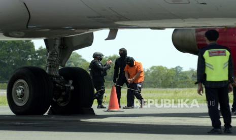 Petugas Densus 88 menggiring tersangka kasus terorisme di Bandara Radin Inten II Lampung Selatan, Lampung, Rabu (16/12/2020). Sebanyak 23 tahanan kasus terorisme yang berhasil ditangkap Densus 88 di sejumlah wilayah di Lampung dipindahkanke Mabes Polri. 