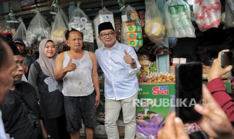 Ridwan Kamil berfoto bersama pedagang saat melakukan blusukan ke Pasar Inpres Kebon Melati di kawasan Kebon Melati, Tanah Abang, Jakarta, Ahad (14/9/2024).