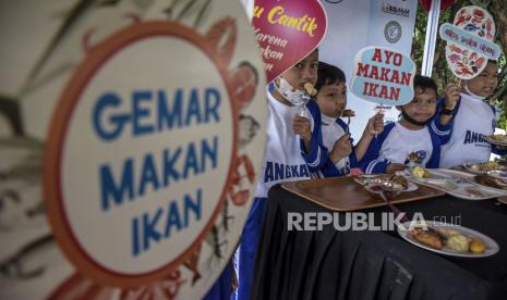 Sejumlah anak memakan olahan ikan pada Festival Ikan Milenial 2022 di Gedung Sate, Kota Bandung, Jumat (2/12/2022). Acara itu diadakan sebagai salah satu cara mengatasi stunting di kalangan anak, khususnya dari keluarga tidak mampu.