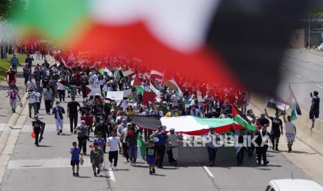 Pengunjuk rasa yang mendukung warga Palestina berjalan di Michigan Ave., ketika Presiden Joe Biden mengunjungi pusat kendaraan listrik Ford di dekatnya, Selasa, 18 Mei 2021