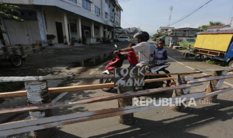 Pengendara motor berbalik arah karena jalan dan lorong akses masuk ke permukiman warga ditutup sementara di Banda Aceh, Aceh, Selasa (31/3/2020).  Sejumlah gampong (desa) di Kota Banda Aceh dan Aceh Besar melakukan karantina wilayah dengan menutup sementara jalan dan lorong yang menuju kawasan perumahan penduduk sebagai upaya mencegah penyebaran virus Corona (COVID-19) meskipun Pemerintah tidak mengeluarkan peraturan tentang karantina wilayah