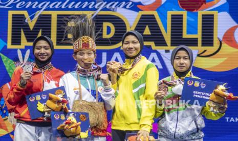 Atlet taekwondo Papua Glorya Rinny Keleyan (kedua kiri) bersama atlet taekwondo Jawa Tengah Tsamarah Tsabitah (kiri), atlet taekwondo Kalimantan Timur Mariska Halinda (kedua kanan) dan atlet taekwondo Riau Hanifah Safitri (kanan) menunjukkan medalinya usai seremoni penyerahan medali  Taekwondo kategori Kyorugi kelas under 53 Kg  putri PON Papua di GOR Politeknik Penerbangan Kayu Batu, Kota Jayapura, Papua, Selasa (5/10/2021). Glorya meraih medali emas, sementara Tsamarah meraih medali perak, medali perunggu diraih Mariska dan Hanifah. 