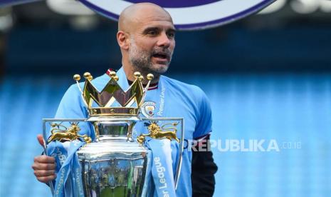 Pelatih Manchester City Pep Guardiola merayakan dengan trofi Liga Primer Inggris setelah pertandingan Liga Primer Inggris antara Manchester City dan Chelsea FC di Manchester, Inggris, Ahad (21/5/2023) malam WIB.