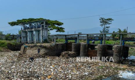 Warga berada diantara tumpukan sampah yang menumpuk di Sungai Citarik, Rancaekek, Kabupaten Bandung, Jawa Barat, Sabtu (28/10/2023). Warga menyatakan sudah hampir seminggu sampah yang didominasi oleh plastik dan styrofom tersebut menumpuk di Sungai Citarik dan warga berharap agar dinas terkait segera mengangkut sampah tersebut karena khawatir akan penyakit yang ditimbulkan. 