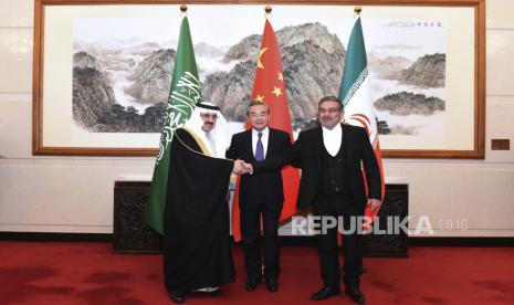 Dalam foto yang dirilis oleh Kantor Berita Xinhua ini, Ali Shamkhani, sekretaris Dewan Keamanan Nasional Tertinggi Iran, di sebelah kanan, berjabat tangan dengan penasihat keamanan nasional Saudi Musaad bin Mohammed al-Aiban, di sebelah kiri, sebagai Wang Yi, diplomat paling senior China, terlihat, di tengah, untuk foto selama pertemuan tertutup yang diadakan di Beijing, Sabtu (11/3/2023). Iran dan Arab Saudi pada Jumat sepakat untuk membangun kembali hubungan diplomatik dan membuka kembali kedutaan setelah tujuh tahun ketegangan. Terobosan diplomatik besar yang dinegosiasikan dengan China menurunkan kemungkinan konflik bersenjata antara saingan Timur Tengah, baik secara langsung maupun dalam konflik proksi di sekitar wilayah tersebut.