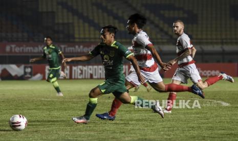 Penyerang Persebaya Surabaya Samsul Arif Munip (kiri) berusaha melewati hadangan pemain Madura United dalam pertandingan lanjutan Grup C Piala Menpora 2021 di Stadion Si Jalak Harupat, Kabupaten Bandung, Ahad (28/3). Dalam pertandingan tersebut Persebaya Surabaya berhasil mengalahkan Madura United dengan Skor 2-1. Foto: Republika/Abdan Syakura