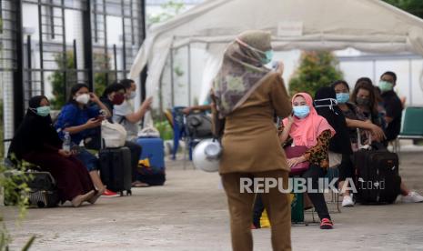 Sejumlah pasien COVID-19 bersiap menaiki bus Sekolah yang akan membawa mereka menuju Rumah Sakit Darurat Wisma Atlet di Puskesmas Kecamatan Duren Sawit, Jakarta, Senin (30/11). Menurut petugas Puskesmas Duren Sawit, sebanyak 20 pasien COVID-19 dibawa menuju Wisma Atlet untuk menjalani isolasi mandiri.Prayogi/Republika.