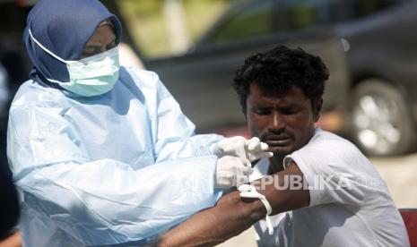 Seorang pengungsi Rohingya menerima pemeriksaan medis di tempat penampungan sementara yang disediakan oleh pemerintah daerah Aceh, di Ladong, Aceh Besar, Indonesia (17/2/2023). Perwakilan UNHCR di Aceh mengumumkan bahwa 69 pengungsi Rohingya mendarat di pantai provinsi Aceh, Indonesia 16 Februari 2023 menyusul ratusan orang yang tiba akhir Januari, melarikan diri dari kondisi putus asa kamp pengungsi di Bangladesh.