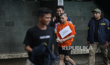 Tersangka kasus pembunuhan Yudha Arfandi digiring oleh polisi saat rekonstruksi pembunuhan di Taman Air Tirtamas Pondok Kelapa, Jakarta Timur, Rabu (28/2/2024). Ditreskrimum Polda Metro Jaya melaksanakan rekonstruksi kasus pembunuhan putra artis Tamara Tyasmara, Raden Andante Khalif Pramudityo alias Dante dengan memperagakan 49 adegan di kolam renang sedalam 1,5 meter.