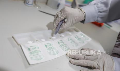 Tenaga farmasi menuangkan racikan obat ke kertas pembungkus di RS Universitas Indonesia, Depok, Jawa Barat, Jumat (21/10/2022). Dinkes DKI ungkap cara kreatif supaya anak tidak takut minum obat puyer. Ilustrasi.