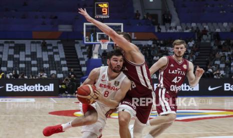 Pebasket timnas Spanyol Dario Brizuela (kiri)  diadang pebasket Latvia  Rodions Kurucs (tengah) di ajang FIBA Basketball World Cup 2023 di Jakarta, Indonesia, 1 September 2023.  