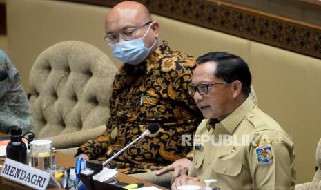 Menteri Dalam Negeri (Mendagri) Tito Karnavian (kanan) bersama Ketua KPU Ilham Saputra saat mengikuti rapat kerja dengan Komisi II DPR di Kompleks Parlemen, Senayan, Jakarta, Senin (24/1/2022). Rapat yang juga diikuti oleh KPU dan Bawaslu tersebut membahas penetapan jadwal pemilu serentak Tahun 2024.Prayogi/Republika.