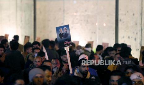 Pendukung Pasukan Mobilisasi Populer Syiah Irak berkumpul di lokasi serangan pesawat tak berawak AS yang menewaskan jenderal Iran Qasem Soleimani dan Abu Mahdi al-Muhandis, wakil pemimpin milisi Pasukan Mobilisasi Populer di jalan utama Bandara internasional Baghdad di Baghdad, Irak , 02 Januari 2021. Ratusan Pendukung Pasukan Mobilisasi Populer Syiah Irak berkumpul di lokasi serangan pesawat tak berawak AS pada peringatan pertama pembunuhan komandan milisi Irak Abu Mahdi al-Muhandis dan Qasem Soleimani, kepala Revolusi Islam Iran Pasukan Quds elit Korps Pengawal, dan delapan lainnya di bandara internasional Baghdad pada 03 Januari 2020.