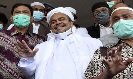  Ulama Indonesia dan pemimpin Front Pembela Islam Rizieq Shihab, tengah, melambai pada wartawan setibanya di Mabes Polri di Jakarta, Indonesia. Sabtu, 12 Desember 2020.