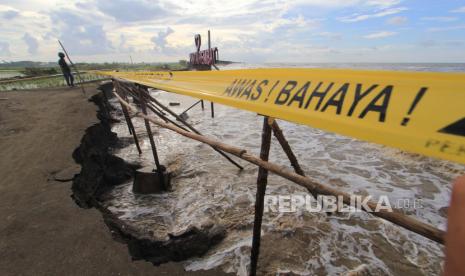 Warga melinat kondisi pantai yang tergerus abrasi di Juntinyuat, Indramayu, Jawa Barat, Rabu (3/6/2020). Selain merusak kawasan wisata pantai dan areal persawahan, abrasi akibat ombak besar yang tejadi sejak lima hari terakhir itu juga mengancam saluran pipa milik Pertamina Gas