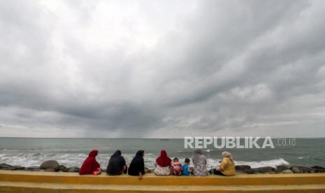 Sejumlah pengunjung menikmati pemandangan laut di pantai wisata Jawa-Hagu (JAGU), Kota Lhokseumawe, Aceh, Selasa (7/12/2021). Kementerian PUPR melalui program Kota Tanpa Kumuh (Kotaku) mengembangkan kawasan kumuh kota menjadi destinasi wisata kuliner Pantai JAGU untuk membangkitkan ekonomi masyarakat melalui pariwisata. 