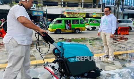 Wali Kota Bogor Bima Arya Sugiarto, memantau sambil mencoba membersihkan trotoar di Alun-Alun Kota Bogor. PKL di Alun-Alun Bogor bermain 'kucing-kucingan' saat Bima Arya melakukan sidak.