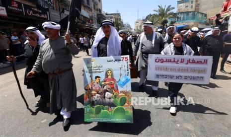 Warga Palestina menghadiri rapat umum yang memperingati hari Nakba di kota Ramallah, Tepi Barat, 15 Mei 2023. Warga Palestina memperingati 75 tahun Hari Nakba (Hari Malapetaka), diperingati setiap tahun pada tanggal 15 Mei untuk mengenang pemindahan mereka setelah Deklarasi Kemerdekaan Israel 1948 .