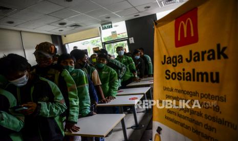 Sejumlah pengendara ojek online saat mengantre untuk mengambil pesanan BTS Meal di McDonalds Raden Saleh, Cikini, Jakarta, Rabu (9/6). Satpol PP DKI Jakarta menutup sementara McDonalds Raden Saleh  karena terjadinya kerumunan yang mengabaikan protokol kesehatan. Kerumunan tersebut diakibatkan pesanan BTS Meal yang merupakan menu kolaborasi boy band asal Korea BTS dengan McDonalds yang hadir di 50 negara, termasuk Indonesia. Republika/Putra M. Akbar