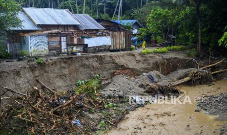 Korban Banjir Bandang Sigi Siap Direlokasi. Warga berada di dekat rumah yang terancam ambruk akibat abrasi sungai di Desa Simoro, Kabupaten Sigi, Sulawesi Tengah, Senin (6/7/2020). Pemerintah setempat mengingatkan warga yang bermukim di bantaran sungai untuk mewaspadai bencana alam banjir, longsor,  dan abrasi sungai menyusul tingginya intensitas hujan dalam sepekan terakhir ini. 