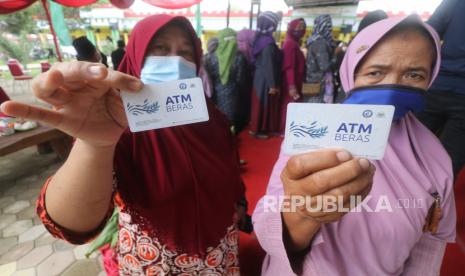 Warga memperlihatkan kartu Anjungan Tunai Mandiri (ATM) beras di Masjid Syech Abdul Qodir Jaelani, Desa Mangunrejo, Kediri, Jawa Timur, Senin (21/2/2022). Yayasan Baitul Maal Bank Rakyat Indonesia (YBM BRI) membagikan 50 kartu ATM Beras kepada masyarakat miskin guna mengambil beras sebanyak 3 kilogram per minggu selama satu tahun. 