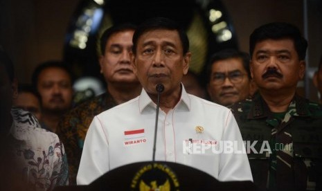 Menteri Koordinator Politik, Hukum dan Keamanan, Wiranto (tengah) memberikan keterangan kepada media usai melaksanakan rapat koordinasi khusus tingkat menteri di Kantor Kemenkopolhukam, Jakarta, Jumat (22/6).