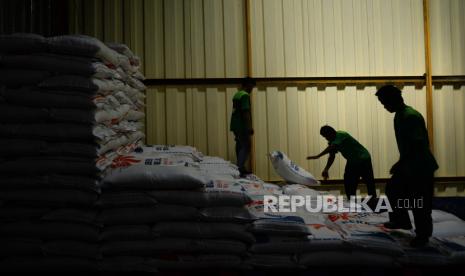 Pekerja melakukan bongkar muat karung berisi beras di Gudang Beras Food Station, Cipinang, Jakarta, Jumat (3/2/2023). Menteri Perdagangan Zulkifli Hasan mengingatkan para pedagang jangan menjual beras Bulog oplosan karena akan berhadapan dengan Satgas Pangan.