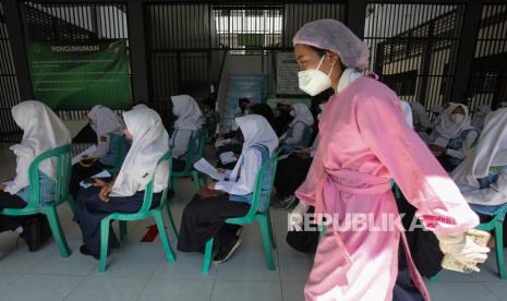 Sejumlah pelajar SMP Negeri 60 Surabaya mengantre untuk tes usap PCR di SMP Negeri 60 Surabaya, Jawa Timur, Selasa (28/9/2021). Dinas Kesehatan Kota Surabaya melakukan tes usap PCR kepada 965 pelajar, sejumlah guru serta tenaga pendidik di sekolah tersebut sebagai upaya antisipasi penyebaran COVID-19 menyusul akan dimulainya pembelajaran tatap muka terbatas di tempat itu. 