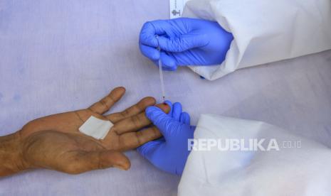 Petugas medis mengambil sample warga yang akan mengikuti tes cepat (Rapid Test) COVID-19 