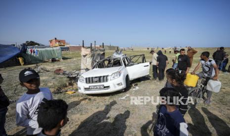 Orang-orang memeriksa lokasi di mana pekerja World Central Kitchen terbunuh di Deir al-Balah, Jalur Gaza, Selasa, (2/4/2024).