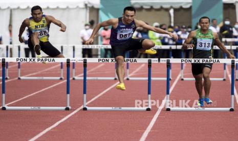 Pelari putra Jawa Barat Halomoan Edwin Simanjuntak (tengah) berusaha melompati gawang saat bertanding pada final nomor Lari 400 meter Gawang Putra PON Papua di Stadion Atletik Mimika Sport Center, Kabupaten Mimika, Papua, Minggu (10/10/2021). Halomoan berhasil meraih medali emas pada nomor tersebut, sementara pelari Sumatera Utara M. Khairuddin meraih medali perak dan pelari Nusa Tenggara Barat Andrian meraih medali perunggu. 