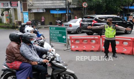 Ilustrasi. Polisi mengarahkan pengguna jalan ke jalur alternatif saat mengatur arus lalu lintas di jalur mudik di jalan utama kota Temanggung, Jawa Tengah Sabtu (30/4/2022). Satlantas Polres Temanggung melakukan rekayasa lalu lintas dengan mengubah arus lalu lintas menjadi dua arah untuk menghindari kemacetan di kawasan pasar Kliwon. Urai Kemacetan di Pasar Kliwon Temanggung, Polisi Berlakukan Rekayasa Lalu Lintas