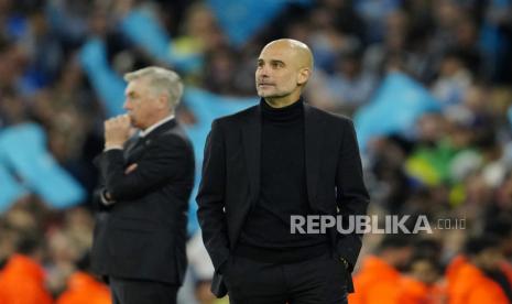  Pelatih kepala Manchester City Pep Guardiola dan pelatih kepala Real Madrid Carlo Ancelotti (kiri) berdiri di pinggir lapangan pada menit-menit terakhir pertandingan sepak bola leg kedua semifinal Liga Champions antara Manchester City dan Real Madrid di stadion Etihad di Manchester, Inggris, Kamis (18/5/2023) dini hari WIB.