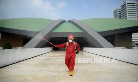 Petugas Pemadam kebakaran menyemprotkan cairan disinfektan di area Kompleks Gedung DPR/MPR RI, Jakarta.