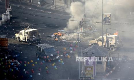 Kendaraan militer Israel melintasi jalan saat bentrok dengan kelompok perlawanan Palestina di Jenin, Tepi Barat, pada 4 Juli 2023. 