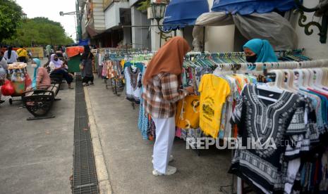 Pedagang melayani pembeli cenderamata di Malioboro, Yogyakarta, Selasa (25/1/2022). Gubernur DIY Sultan HB X memastikan  pemindahan pedagang kaki Lima (PKL) Malioboro akan dilakukan pada Rabu (26/1/2022) sebagai permulaan. Menurutnya proses pemindahan itu akan berlangsung antara dua hingga tiga pekan ke depan.