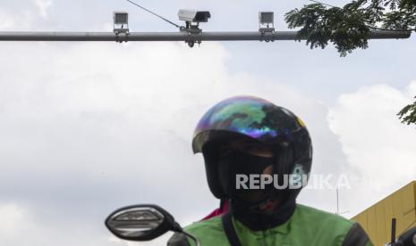 Pengendara melintasi di bawah kamera pengawas atau Closed Circuit Television (CCTV) ilustrasi. Direktorat Lalu Lintas Polda Metro Jaya mengembangkan kamera tilang elektronik (Electronic Traffic Law Enforcement/ETLE) yang dapat mendeteksi pengendara tidak memiliki Surat Izin Mengemudi (SIM). 