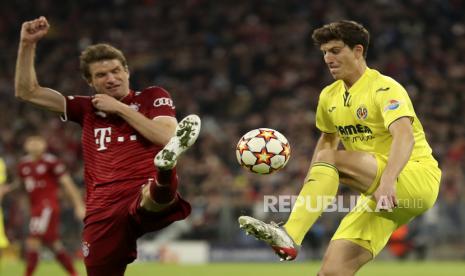  Pau Torres (kanan) dari Villarreal beraksi melawan Thomas Mueller (kiri) dari Bayern Munich selama perempat final Liga Champions UEFA, pertandingan sepak bola leg kedua antara Bayern Munich dan Villarreal CF di Munich, Jerman, 12 April 2022.