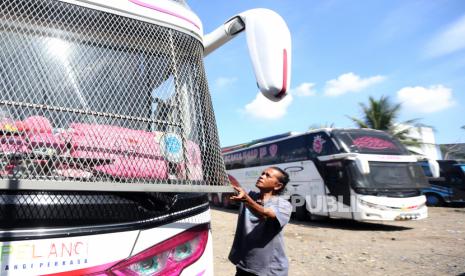 Pekerja memeriksa dan membersihkan jaring besi pelindung kaca depan bus antar kota antar provinsi yang akan melayani angkutan mudik Idul Fitri 1443 H di Banda Aceh, Aceh. Juru Bicara Pemerintah untuk Penanganan Covid-19 Wiku Adisasmito mengingatkan masyarakat yang akan mudik untuk membuat perencanaan perjalanan yang matang. Wiku mengatakan, ini karena diprediksi akan terjadi kepadatan pada mudik lebaran Idul Fitri tahun ini.