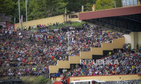 Sejumlah warga menyaksikan pertandingan antara tim sepak bola Papua dengan tim sepak bola Aceh pada final Sepak Bola Putra PON Papua di Stadion Mandala, Kota Jayapura, Papua, Kamis (14/10/2021). Tim sepak bola putra Papua menang atas Aceh dengan skor 2-0. 