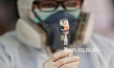 Seorang pekerja medis menunjukkan botol vaksin Sinovac COVID-19 yang diproduksi oleh perusahaan farmasi milik negara Indonesia Biofarma selama kampanye vaksinasi untuk anak-anak antara 12-17 tahun di sebuah sekolah di Tangerang, Indonesia, Rabu, 14 Juli 2021. 