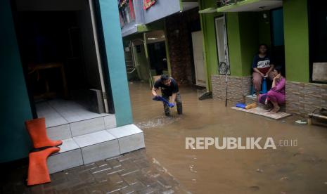 Warga melintasi banjir yang merendam kawasan Kebon Pala, Kampung Melayu, Jakarta, Sabtu (16/7/2022). Banjir setinggi 40-170 centimeter tersebut terjadi akibat meluapnya air sungai Ciliwung yang dipicu oleh tingginya curah hujan yang mengguyur wilayah Jakarta, Bogor, dan Depok sejak Jumat (15/7/2022) malam hingga Sabtu pagi.Prayogi/Republika.