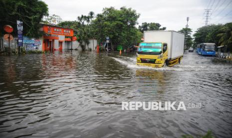 Pengendara melintasi banjir di Jakarta Utara (IKUSTRASI).